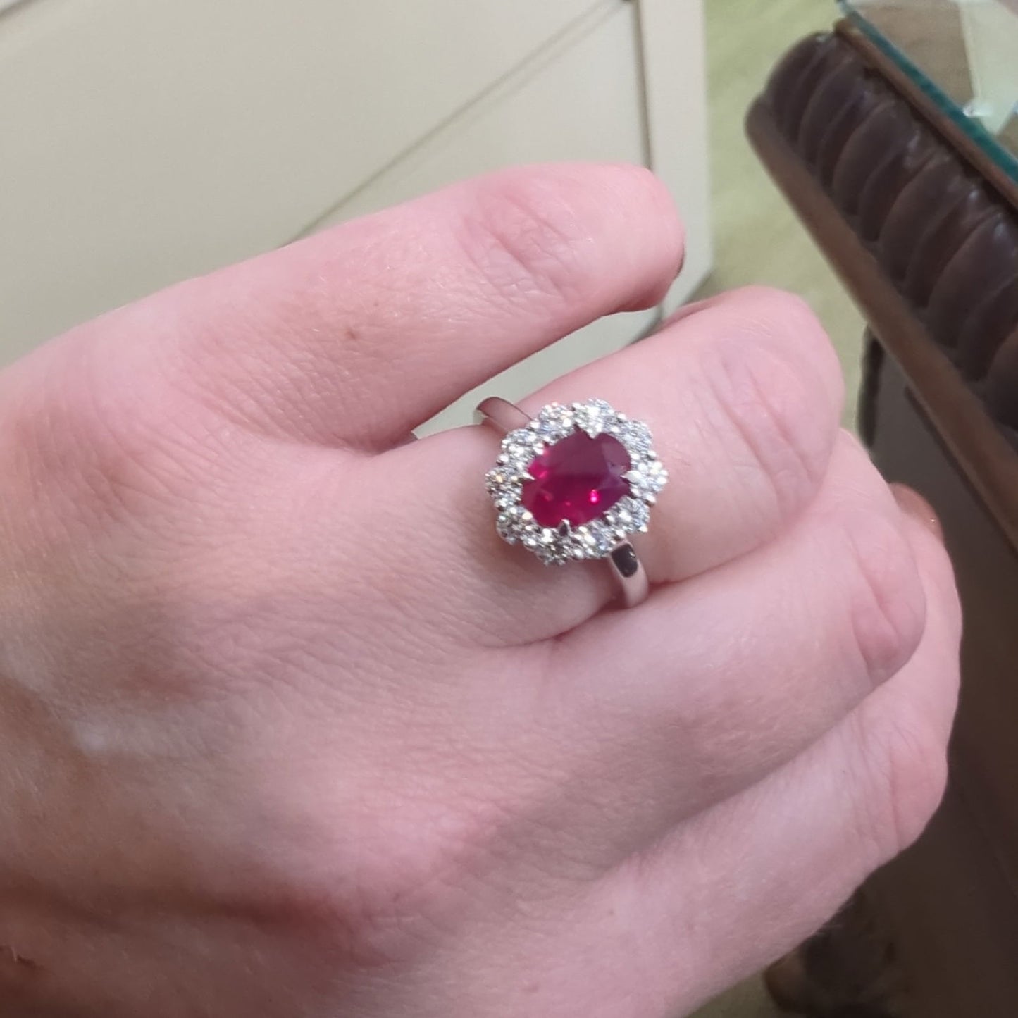 Photo of Zoma Color Ruby Halo Ring in a decorative scene, designed by , available at Plumb Gold & Plumb Silver