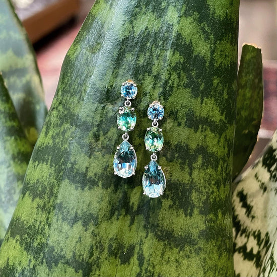 Photo of quamarine Tourmaline Dangle Earrings in a decorative scene, designed by , available at Plumb Gold & Plumb Silver